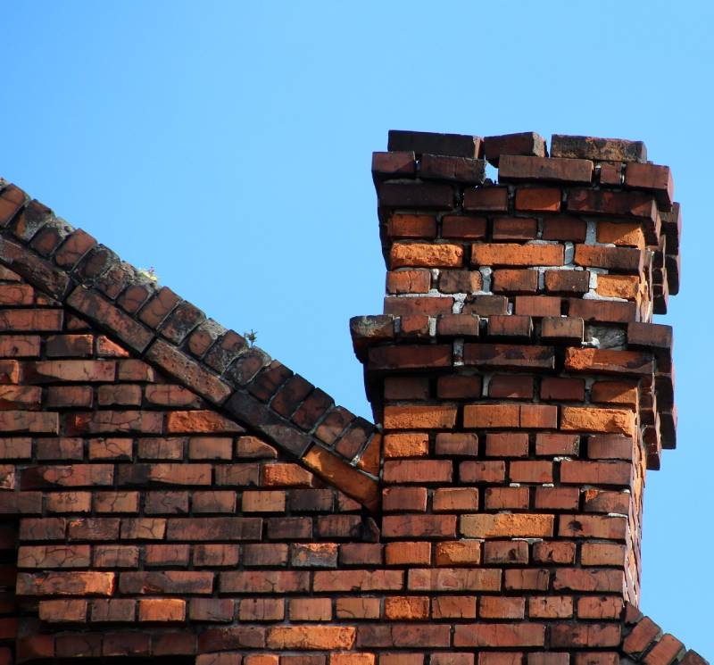 Signs Your Brownsville Home Needs a Chimney Inspection Damaged chimney on an Brownsville home showing cracks and missing mortar